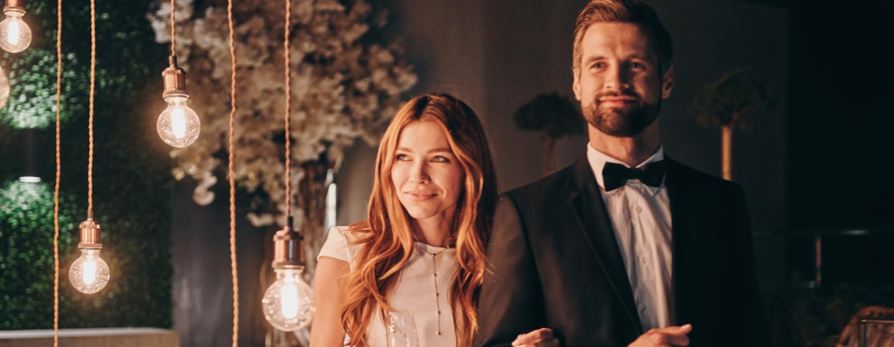 a man and woman holding wine glasses