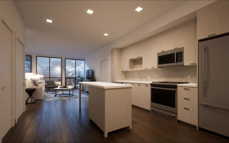 a kitchen with a wood floor an island and white cabinets