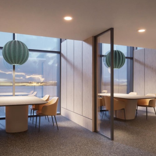 a work room with tables and chairs by large windows